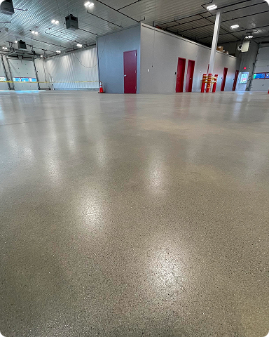 Bright, glossy polished concrete floor in a sunlit commercial and industrial facility