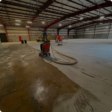 Concrete grinding equipment in a large industrial warehouse